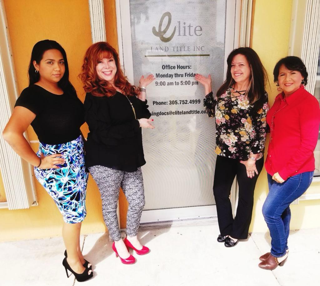 Elite Land Title team at the front office entrance